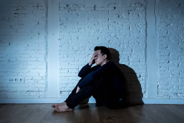 Portrait of sad depressed young man crying devastated feeling hurt suffering Depression in People, Sadness, Emotional pain, Loneliness and Heartbroken concept with copy space and dark mood light.