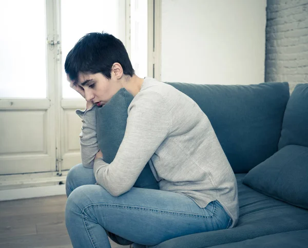 Beautiful desperate and depressed young woman on sofa feeling sad, hopeless and in pain suffering from Depression in People, Mental health,broken heart, Grief and Psychology concept.