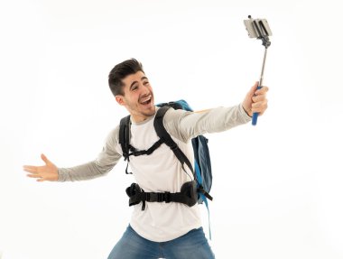 Portrait of young backpacker taking a selfie with his mobile phone isolated on white background. In traveling around the world, staying connected, tourism and social network, living the dream concept. clipart