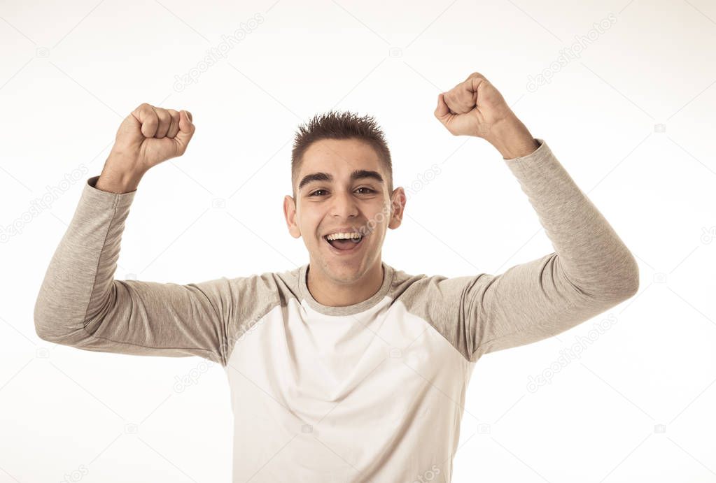 Portrait of young man celebrating achieving his goal, wining the lottery or having great success in face expression human emotions and surprised and happy facial expression isolated on grey.