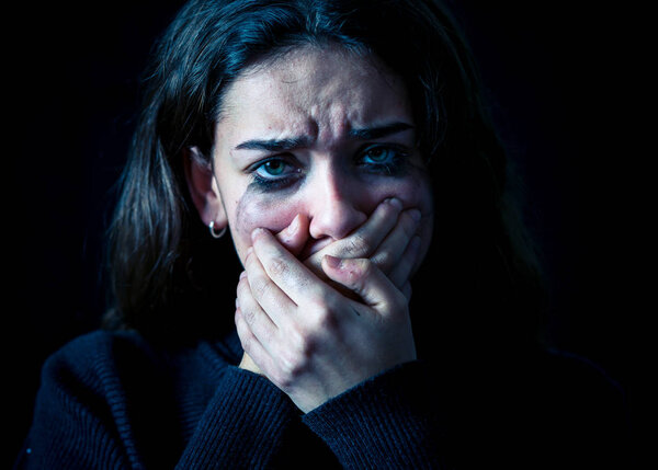 Dramatic closeup portrait of young scared, depressed girl crying alone, feeling hopeless suffering from harassment or domestic violence. Stop child abuse and neglect. Social campaign concept.