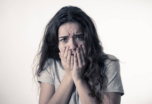 Close up portrait of scared and shocked young teenager female Looking surprised with fear in her eyes. People and Human expressions and emotions concept. isolated on white.