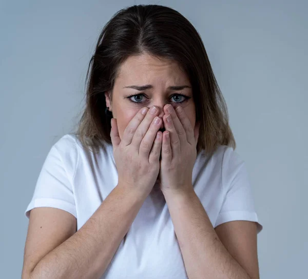 Close up of young woman feeling scared and shocked making fear, anxiety gestures. Looking terrified and desperate. People and Human expressions and emotions concept. Isolated on neutral background.