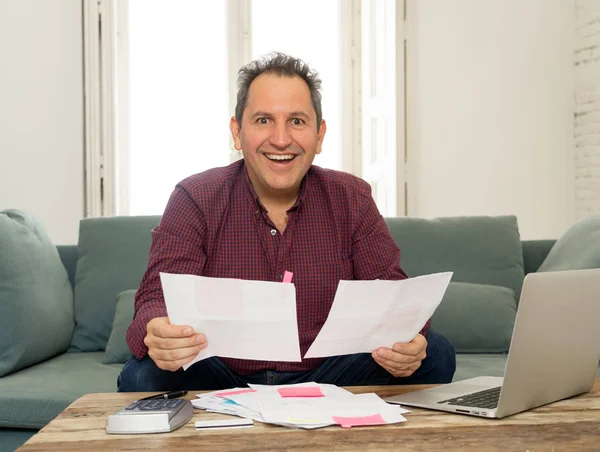 Successful middle aged man with payslips, invoices and computer accounting finance Happy free of debts — Stock Photo, Image