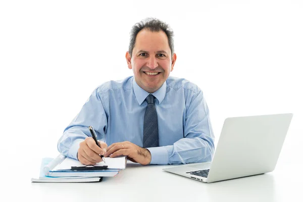 Attractive happy mature caucasian businessman working on laptop computer feeling successful at work Stock Picture