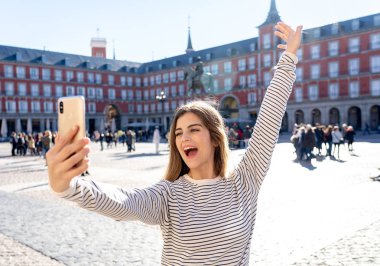 Güzel genç beyaz öğrenci turist kadın bir selfie veya onu turizm ve seyahat etmek çevrede Dünya blog web Plaza Mayor Madrid İspanya için video alma. Sosyal medya ve Avrupa'da tatil.