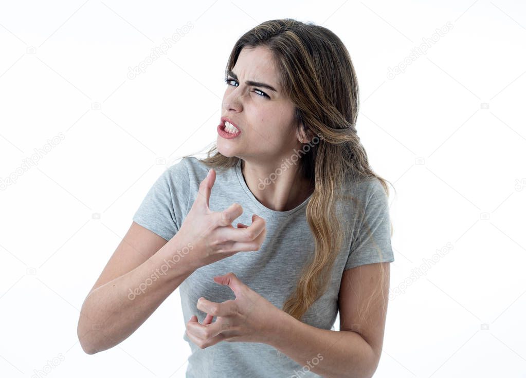 Close up of young attractive caucasian woman with an angry face. Looking mad and crazy shouting and making furious gestures. Isolated on white background. Facial expressions and emotions.