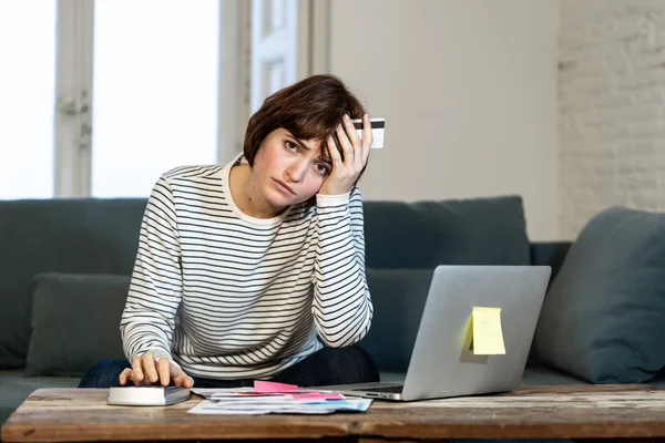 在家里的沙发上 担心和绝望的女人感到压力很大的支付信用卡债务和笔记本电脑账单的肖像 在商业和家庭财务和财务问题的概念 — 图库照片