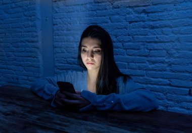 Siber zorbalık ve taciz acı akıllı cep telefonu üzücü korkmuş genç kadının dramatik portresi. Yalnız, depresif ve korku online Stalker tarafından istismar olma hissi. İnternet tehlikeleri.