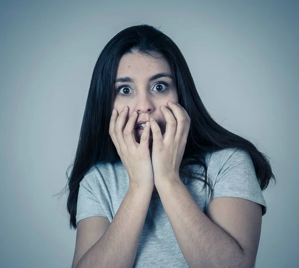 Close up of young woman feeling scared and shocked making fear, anxiety gestures. Looking terrified and covering herself from something. Copy space. People and Human expressions and emotions concept.