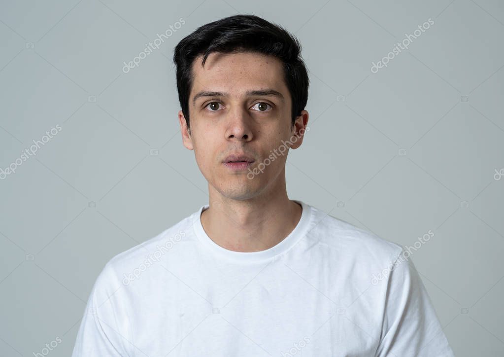 Young man feeling scared and shocked making fear, anxiety gestures. Looking terrified and desperate trying to cover himself. Portrait with copy space. People and Human expressions and emotions.
