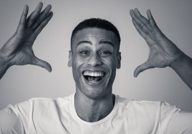 Portrait of Amazed excited african american Man achieving his goal or wining, laughing showing Victory gesture in Happy face facial expression, Human emotions happiness. Isolated on grey background. clipart