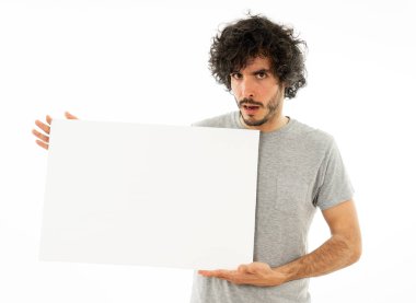 Komik ve iyi görünümlü bin yıllık adam gösteren ve reklam metni için kopya alanı ile boş tahta işaret. Mutlu sürpriz ve büyük reklam şok bakıyor. Pazarlama konsepti.