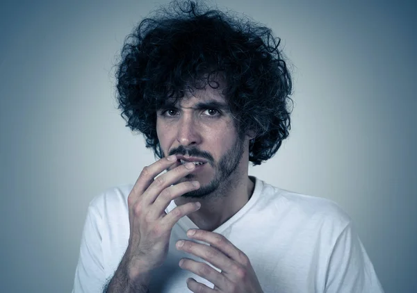 Portrait of young man feeling disgusted and shocked at some violent scene or smelling or disgusting thing. Isolated on neutral background. People and Human expressions and negative emotions.