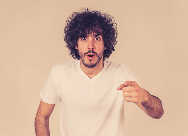 Portrait of funny attractive young man with happy and surprised face pointing and looking excited at something shocking and good. Human emotions, facial expressions. Advertising, sales or winning.