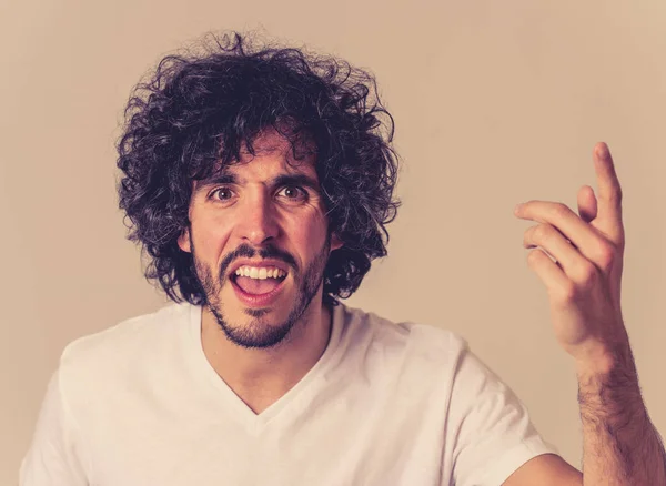 Annoyed young millennial man with an angry face looking mad and furious feeling frustrated. Close up studio shot Isolated on white background. People, Facial expressions and negative emotions.