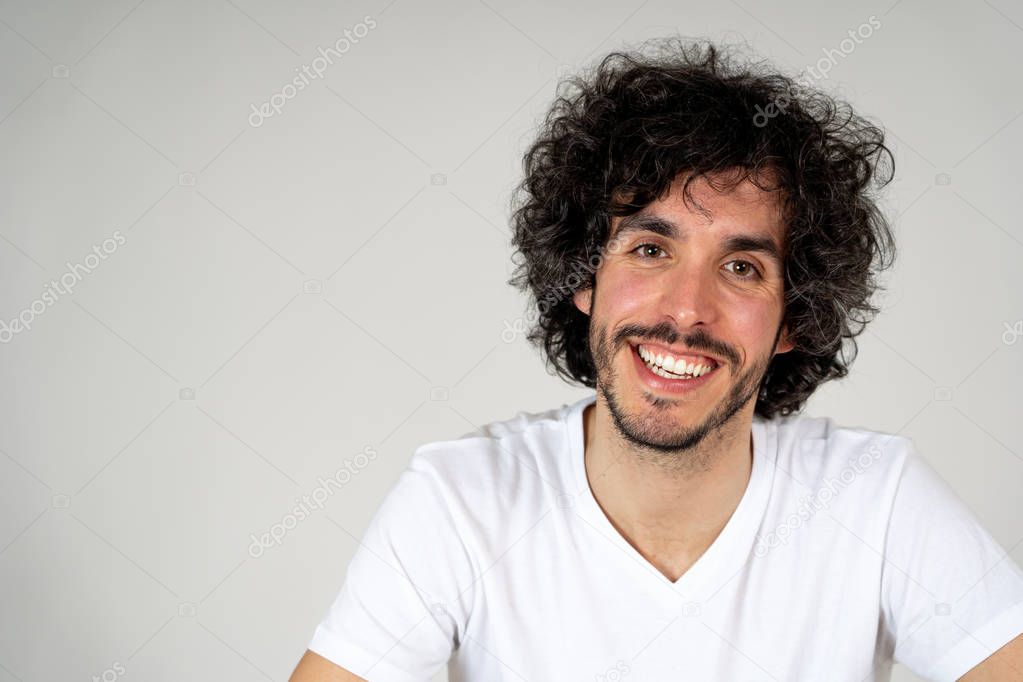 Portrait of young attractive stylish fashion man in his 20s looking sexy posing against neutral background. Millennial happy model sweet and funny. In People, hipster and Beauty concept.