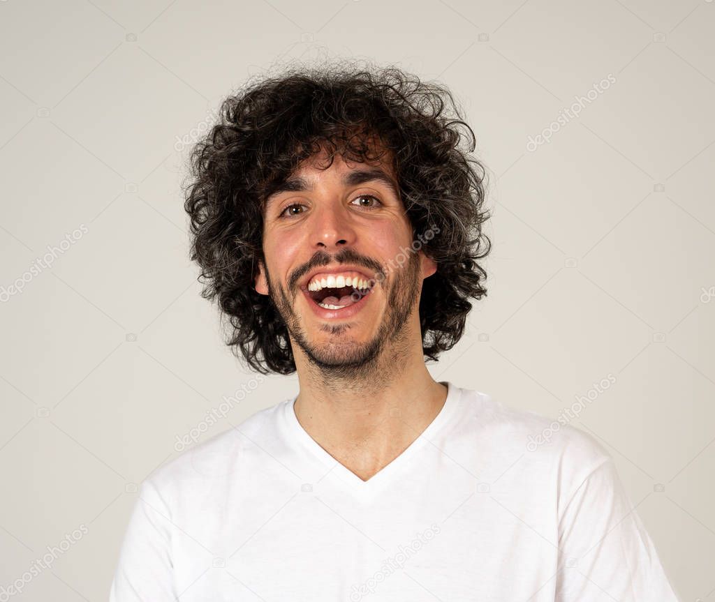Portrait of attractive young model with happy face, beautiful smile and funny hair style. Handsome millennial man in his 20s. Studio shot. In People, fashion and human facial expressions and emotions.