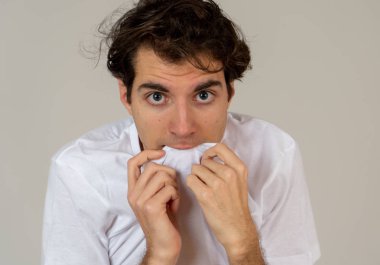 Genç adam korkar ve korku ve anksiyete içinde korkmuş jestler yapma şok hissediyor. Korkmuş ve çaresiz kendini örtbas etmeye çalışıyor. Boşluk Kopyala. İnsanlar ınsan ifadeleri ve duygusal reaksiyonlar.