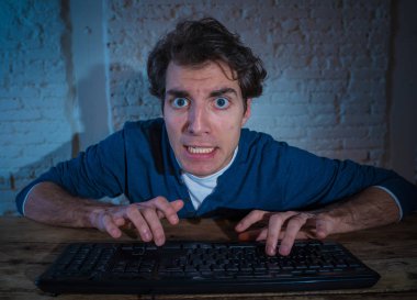 Bilgisayar laptop hissi geceleri yalnız bağımlısı genç adam vurguladı ve iş bitirmek veya online oyun veya kumar kazanmak için çalışırken boğulmuş. İşkolik ve internet teknolojisi bağımlılığı.