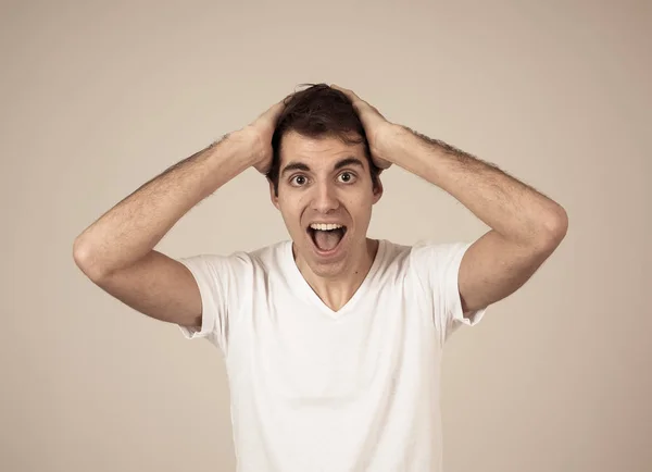 Portrait Of Young Man In Shock With Scared Face Paralysed With