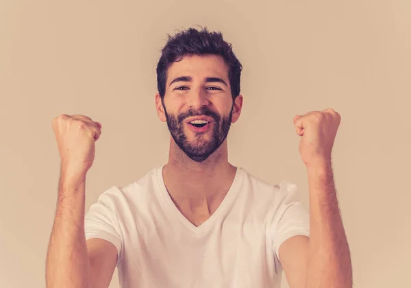 Portrait of young happy and excited man winning the lottery celebrating goal or having great success with proud face. In People success and Facial Expression and positive Human Emotions.