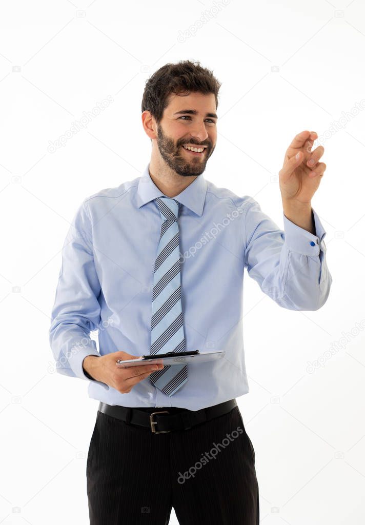 Young attractive businessman pointing at copy space as using a virtual screen. Smiling feeling confident and successful. In people business education, success and new technology at work concept.