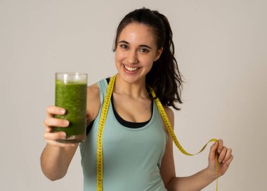 Fitness kadın gevşek kilo diyet planı ile mutlu gülümseyen; egzersiz ve yeşil sebze smoothie sağlıklı içecek. Güzellik vücut bakımı, Sağlık Fitness Diyet Beslenme ve sağlıklı Yaşam tarzı kavramı.