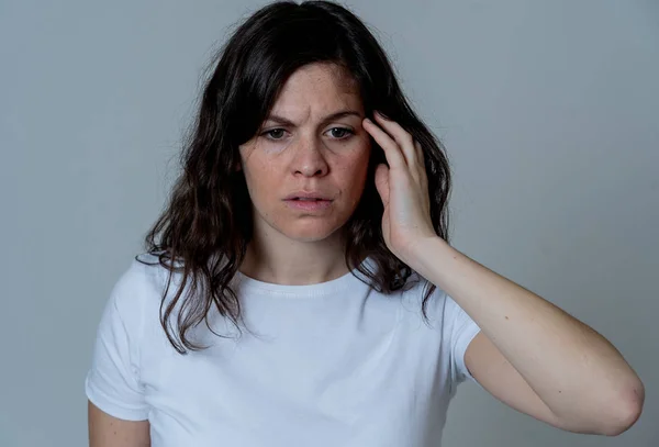 Human emotions and expressions and mental health concept. Young sad woman suffering from depression looking worried and thoughtful. Feeling sorrow and emotional pain. Studio shot With copy space.