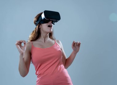 Meraklı kadın mutlu ve sanal gerçeklik gözlük simülasyon hakkında heyecanlı duygu kullanmak için heyecanlı, sanal hayat mutlu jestleri yapma keşfetmek. Yeni teknoloji sanal Augmented gerçeklik kavramı.