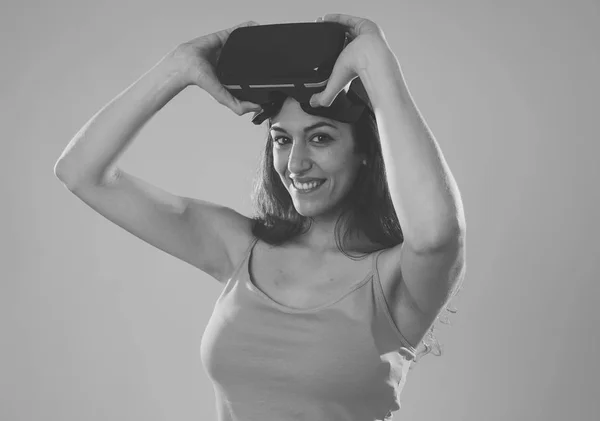 Virtual reality experience. Young caucasian happy woman about to use VR goggles feeling excited about simulation and exploring virtual life. In New technology Virtual Augmented Reality concept.