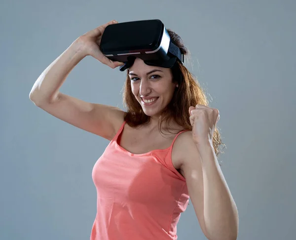 Virtual reality experience. Young caucasian happy woman about to use VR goggles feeling excited about simulation and exploring virtual life. In New technology Virtual Augmented Reality concept.