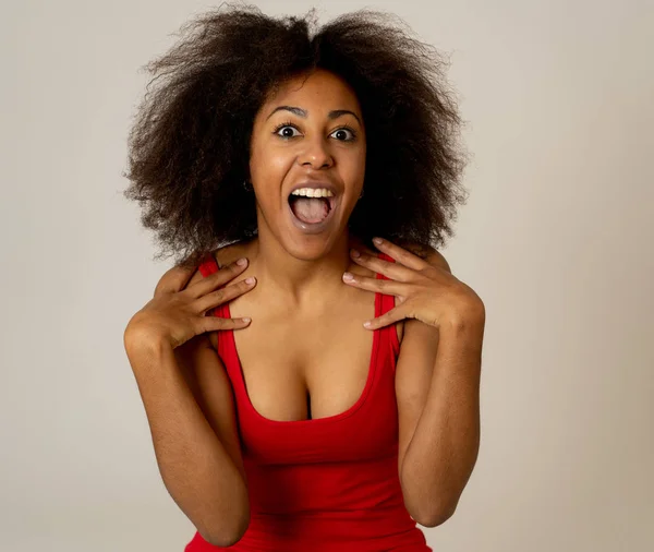 Happy portrait of beautiful young african american female laughing and enjoying life posing in red summer top. Image friendly for advertising. People fashion Human emotions and expressions.