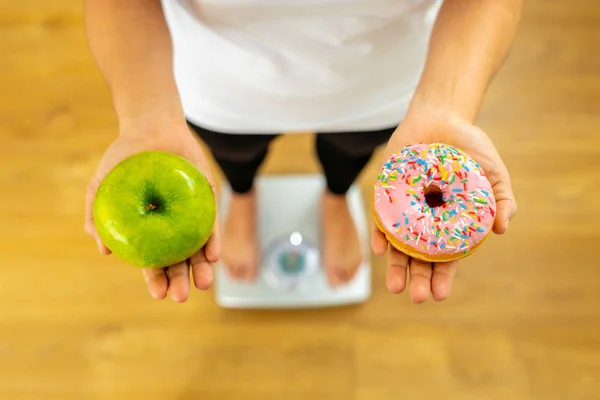 Close Woman Scale Holding Hands Apple Doughnut Making Choice Healthy — Stock Photo, Image