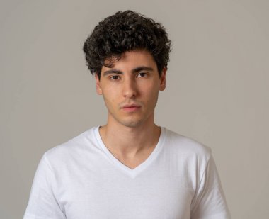 Çekici, portresi bakarak tarafsız, rahat ve ciddi insanlar yüz ifadeleri, insan duyguları, başarı ve eğitim kavramı kendine güvenen genç adam kapatın. Gri arka plan üzerinde izole.