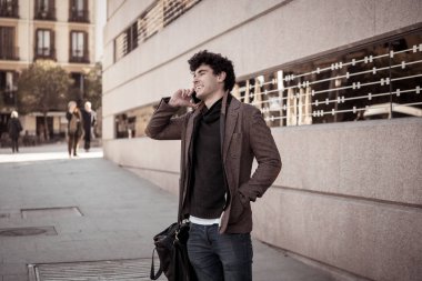 Söz ve akıllı telefon üzerinde sosyal medya arkadaşıyla tatil günlerinde Avrupa'da sohbet mutlu onun yirmili genç çekici adam. İletişim, teknoloji internet ve yaşam tarzı konsepti.