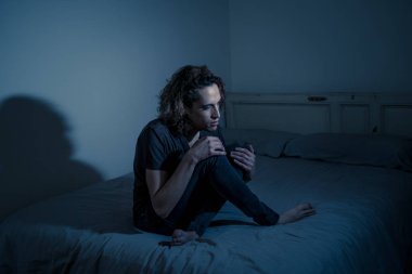 Harap bin yıllık adam üzgün duygu acı ve umutsuz acı Depresyon ağlıyor. Geceleri umutsuzluk içinde yatakta tek başına oturan zorbalık veya istismar depresif genç kurbanı. Genç Ruh sağlığı.