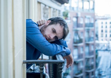 Yalnız üzgün adam ev balkonun depresif sıkıntı ve sefil hissi dışarı bakıyor. Erkekler depresyon ve zihinsel sağlık zor önemli yaşam kararı hakkında düşünme acı duygusal kriz.