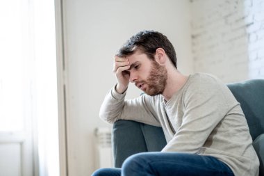Mutsuz beyaz erkek oturan ve oturma odası kanepede yatarken depresif depresyonu yalnız bir acı duygu çaresiz. İş, anksiyete, kalbi kırık ve erkekler sağlık kavramı vurguladı içinde.
