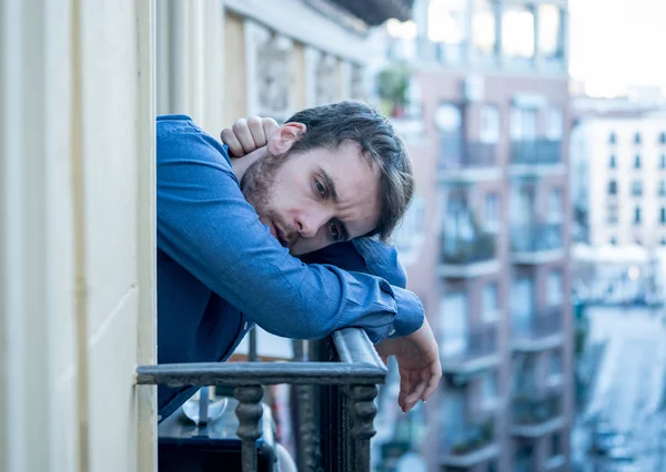 Lonely sad man staring outside house balcony feeling depressed distress and miserable. Suffering emotional crisis thinking about difficult important life decision In Men Depression and mental health.