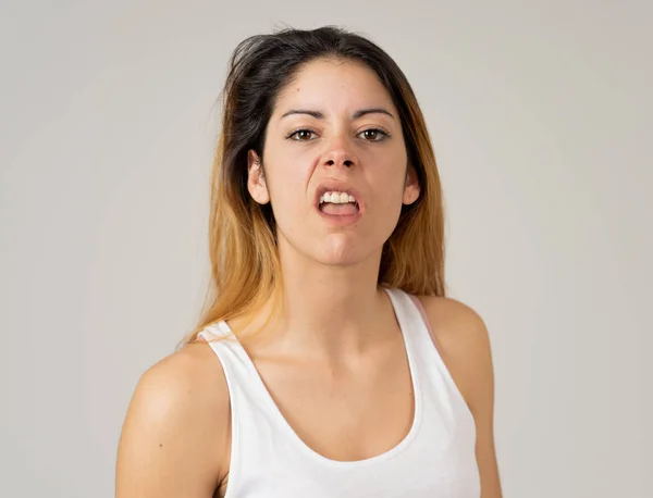 Facial expressions, emotions Anger. Young attractive caucasian woman with angry face. Looking mad and aggressive making furious gestures. Studio portrait in People adolescent mental health concept.