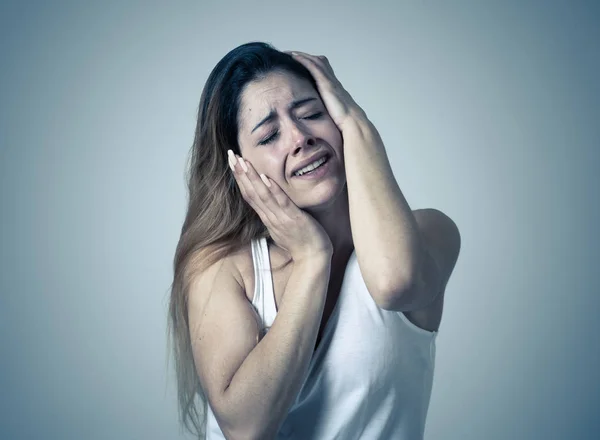 Young woman suffering from depression feeling miserable hopeless and suicidal. Portrait of depressed teen female crying in distress. Facial expressions Human emotions and Mental health concept.