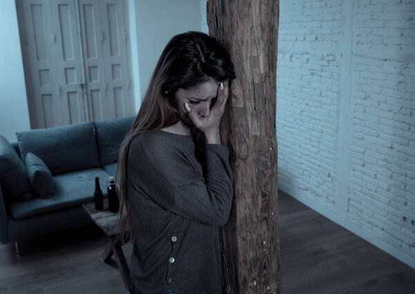 Social issues Domestic violence concept. Woman victim of spouse intimate abuse and physical aggression feeling hopeless and scared crying in distress powerless to stop violence.