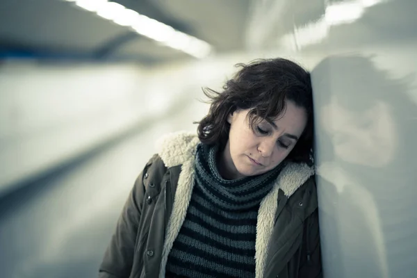 Hopeless and exhausted woman suffering depression and anxiety in subway tunnel in Work-life balance issues Negative body image Financial troubles and Stressful life events Mental health and loos of loved one.