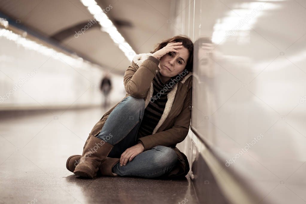 Young adult felling shame depressed and hopeless sitting alone on subway city ground in Depression Loneliness Mental health Emotional pain Social violence Abusive relationship and Harassment concept.
