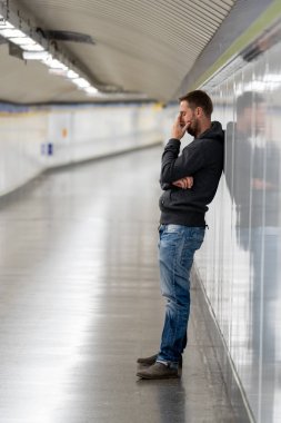 Üzgün işsiz genç adam ağlayan acı depresyon stres zemin sokak Metro'ya eğilerek duvar ruhsal bozukluk duygusal acı uyuşturucu yalnız ve alkolizm umutsuz seyir üzerinde oturan.