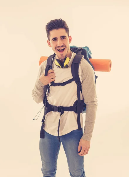 Portrait of happy cool latin man with backpack isolated on white background. In traveling the world, youth and living the dream, holidays student exchange and tourism and adventure vacation concept.