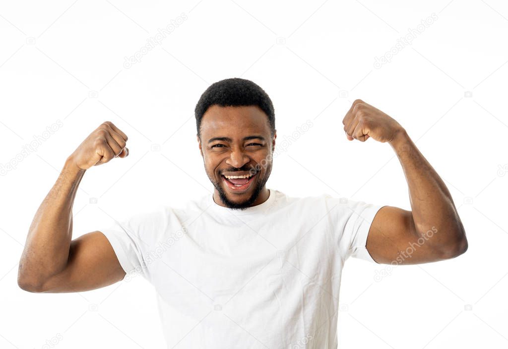 Young strong handsome african american man showing arms muscles smiling proud having fun in people, Happiness, Fitness, success Human emotions and facial expressions concept.