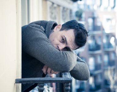 Mutsuz mutsuz genç adam ağlıyor ve intihara meyilli umutsuz, izole ve değersiz ev balkon içinde insanlar depresyon ve ruh sağlığı kavramı üzerinde sokakta bakıyordu duygu depresif. Kentsel arka plan.