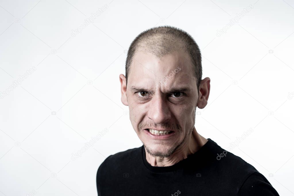 Portrait of angry and upset young man looking furious, aggressive and crazy in People and human emotions, facial expressions and abuse, violence and bullying concept. Isolated on white background.